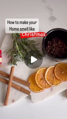 orange slices, cinnamon sticks and spices on a white counter top with the words how to make your home smell like christmas