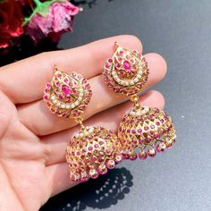 Featuring a pair of ruby pearl jhumkis in gold plated silver. All pearls are freshwater pearls, the setting stones are ruby alike stones and the hanging beads are real rubies. Luxury Ruby Meenakari Jhumkas, Luxury Ruby Latkans Earrings, 22k Gold Jewelry Necklaces, Jadau Jewellery, 22k Gold Jewelry, Hanging Beads, Red Stones, Pearl Necklace Set, Gold Jewelry Necklace