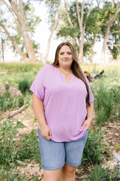 Be a breath of fresh air in the Octavia Blouse. This playful Lavender blouse features a notched neck, dolman sleeves, and a round hem. Perfect for adding a fun touch to any outfit. Fits true to size. Model is wearing a 1X and is 5'7". Size Chart Length Bust 1x 26.5" 52" 2x 28.5" 54" 3x 29" 56" *All measurements are approximate and done while hanging.* Fabric and Care 96% Polyester 4% Spandex Hand wash cold. Hang dry. Purple V-neck Blouse For Day Out, Lavender V-neck Summer Blouse, Purple V-neck Top For Day Out, Purple Short Sleeve Spring Blouse, Purple Short Sleeve Blouse For Spring, Casual Purple V-neck Blouse, Versatile Purple Top For Spring, Lavender V-neck Blouse For Spring, Spring Lavender V-neck Blouse