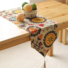 a wooden table topped with a bowl of fruit