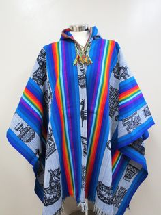 BLUE TONES WITH MULTICOLORED DESIGNS HOODED SHAMAN PONCHO This poncho is made with the Andean Textile handmade with a weaving loom, the fabric is strong and durable. This poncho will fit people's sizes ranging from medium to large. Measurement: 72 X 51 inches (including fringe) Country: Perú Culture: Quechua Material: Alpacryl ( Alpaca and acrylic) Peru Culture, Weaving Loom, Hooded Poncho, Poncho Cape, Loom Weaving, Blue Tones, Alpaca, Loom, Kimono Top