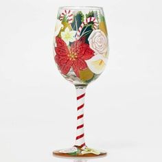 a wine glass decorated with flowers and candy canes