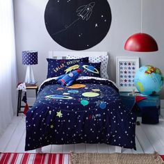 a bedroom with space themed bedding and decor