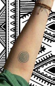 a woman's arm with a small tattoo on the left side of her wrist