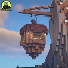 an animated image of a house hanging from the side of a cliff in minecraft