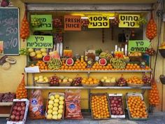 a fruit stand with oranges, lemons and other fruits