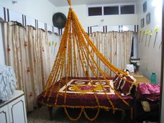 the bed is decorated with beads and orange garlands on it's headboard