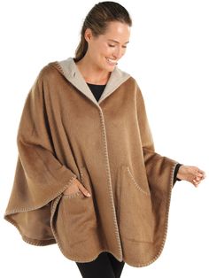 Experience true designer quality without the designer price tag. This luxurious satin-lined cape, 70% suri alpaca and 30% merino wool, wraps you in a cozy all-day caress. Contrasting light and dark Brown interior/exteriors and standout stitching at the edges add striking definition and pique interest—attracting compliments wherever you go. We’ve even added generous pockets so you can mingle with all your essentials. Made in Peru. Cozy Wool Poncho Cape, Wool Cape Shawl For Fall, Alpaca Shawl Outerwear, One Size Alpaca Shawl Outerwear, Fall Wool Cape Shawl, Cozy Alpaca Poncho Cape, One Size Wool Cape Outerwear, Alpaca Shawl Cape For Fall, Alpaca Shawl Outerwear For Winter