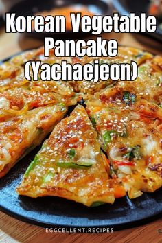 korean vegetable pancake with yachaeleon on a black plate and chopsticks