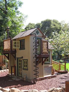 a small wooden play house in the middle of a park