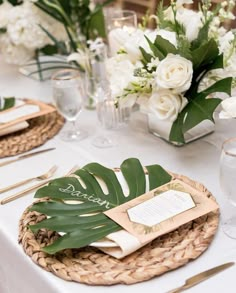 a table set with place settings and flowers