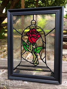 a stained glass window with a rose in it