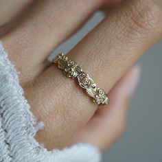 a woman's hand with a gold ring on it