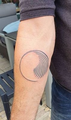 a man's arm with a tattoo on it that has an image of a spiral