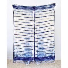 a blue and white blanket hanging on the wall