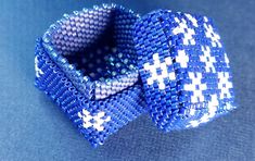 a close up of a blue and white bow tie on a table with a blue background