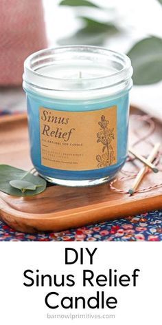 a blue candle sitting on top of a wooden tray