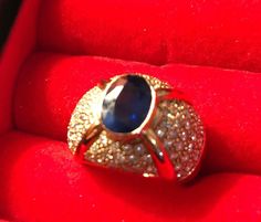 Antique ring which belonged to my late grandmother.  It deserves to be worn and appreciated for all to admire!  This heirloom ring consists of a 24k gold band, an oval-cut blue sapphire, which is surrounded by diamonds. This is a beautiful and unique piece of jewelry to add to one's collection. Appraised at over $12,000, I am asking only 2/3 of the rings true value. Formal descriptions by certified gemologist can be seen in picture of appraisal on this listing. Gold Oval Cabochon Sapphire Ring For Formal Occasions, Formal Gold Oval Cabochon Sapphire Ring, Gold Sapphire Ring With Oval Cabochon For Formal Events, Formal Gold Sapphire Ring With Oval Cabochon, Luxury Oval Diamond Ring With Stone Setting, Formal Sapphire Ring With Oval Cabochon, Gold Oval Cabochon Diamond Ring For Formal Occasions, Gold Diamond Ring Oval Cabochon For Formal Occasions, Luxury Oval Cabochon Sapphire Ring As Gift