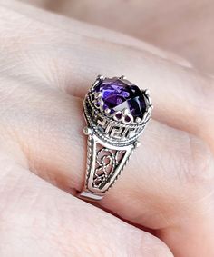 "This everyday use, lace embroidery minimalist sterling 925 sterling silver filigree art crown cocktail ring has amethyst gemstone. The ring face is 0.47\" / 12.00 mm. Amethyst gemstone is 10 mm, double side faceted, checkerboard round-cut. The February birthstone amethyst gemstone would make the perfect option for a birthday gift, anniversary gift, thanksgiving gift, summer gift, valentine's day gift, mother's day gift, to yourself or your daughter, sister, wife, grandma or girlfriend. This met Luxury Silver Amethyst Ring In Modern Style, Sterling Silver Purple Jewelry With Intricate Design, Sterling Silver Amethyst Promise Ring With Intricate Design, Sterling Silver Jewelry With Intricate Design In Purple, Purple Sterling Silver Filigree Jewelry, Purple Sterling Silver Jewelry With Intricate Design, Sterling Silver Amethyst Ring With Intricate Design, Regal Round Silver Jewelry, Classic Sterling Silver Amethyst Ring Gift