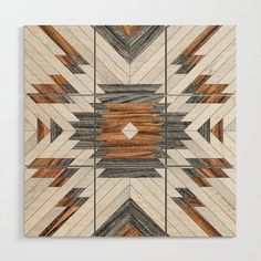 an art piece made out of wood with geometric designs on the top and bottom side