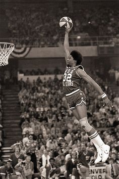 a basketball player jumping up in the air to dunk a ball at a game