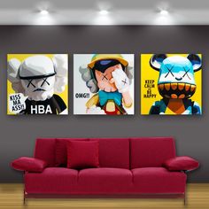 three cartoon characters are hanging on the wall above a red couch in a modern living room