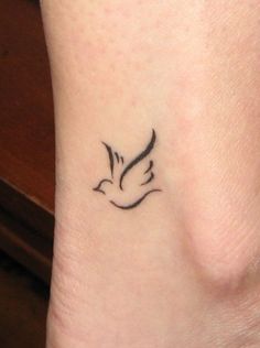 a small bird tattoo on the ankle