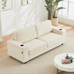 a living room with a white couch and coffee table