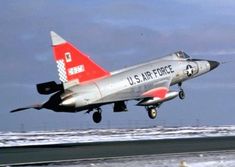 a us air force jet taking off from an airport runway with snow on the ground