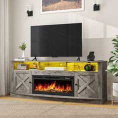 an entertainment center with a television and fire place