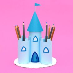 a paper castle with pencils sticking out of it