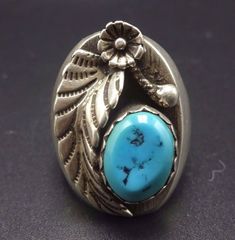 "VINTAGE NAVAJO RING DESCRIPTION: This handsome ring features a gorgeous specimen of Sleeping Beauty turquoise. The gemstone is secure in scalloped bezel, on a foundation of heavy gauge vintage sterling silver. A highly detailed applied leaf flanks the turquoise cabochon. This ring will be a treasured addition to your collection of fine vintage Native American jewelry. MEASUREMENTS: Ring face measures 1 1/8\" x 3/4\" Cabochon measures 12mm x 9mm RING SIZE: 11 WEIGHT: 21.2 grams SIGNED: no STERLI Vintage Sterling Silver Turquoise Ring With Polished Finish, Vintage Blue Turquoise Ring Engraved, Vintage Turquoise Ring With Polished Finish For Anniversary, Antique Style Silver Turquoise Ring, Vintage Turquoise Ring With Polished Finish, Antique Style Untreated Silver Turquoise Ring, Antique Untreated Turquoise Ring In Silver, Heirloom Silver Turquoise Ring, Vintage Sterling Silver Turquoise Ring