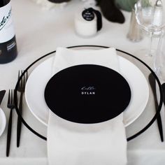 a table set with black and white place settings