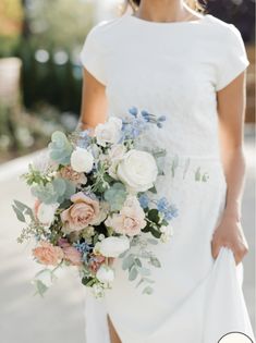 a woman in a white dress holding a bouquet