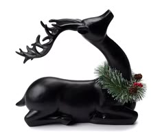 a statue of a deer with antlers on it's back and pine cones in its mouth