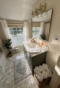 a bathroom with towels stacked on the floor