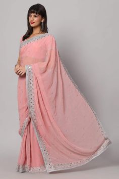 Isn't she pretty in pink in our Aaliya Dusty Rose Silver Embroidered Mirror Work One Minute Saree? This shining Pink Georgette saree isn't just a garment; it's a masterpiece. Each intricate stitch and shimmering mirror detail tell a story of craftsmanship and creativity. With a blouse crafted from the same ethereal fabric, featuring half sleeves and a graceful v-neck, it's a symphony of style. About this Product Saree: Saree Type: Ready to wear, Pre-stitched, Pre-draped Saree Saree Color: Pink S Pink Chinon Pre-draped Saree For Navratri, Pink Chanderi Pre-draped Saree With Sheer Dupatta, Pink Pre-draped Chinon Saree For Navratri, Pink Chanderi Pre-draped Saree For Reception, Pink Chinon Pre-draped Saree For Eid, Chikankari Embroidery Saree For Reception, Eid Pink Blouse Piece With Mirror Work, Pink Unstitched Pre-draped Saree With Mirror Work, Pink Pre-draped Chinon Saree For Diwali