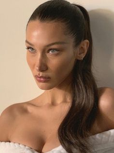 a woman with long hair wearing a white towel