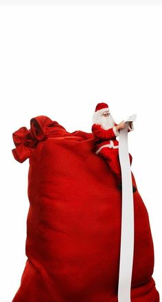 santa claus in a red sack with white ribbon on the side and his head sticking out