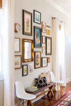 a room with pictures on the wall and a bench