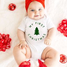 Celebrate your baby's first Christmas with our adorable My First Christmas White Bodysuit, designed to capture the joy and excitement of this special milestone. Key Features: Design: Sweet and charming "My First Christmas" graphic, perfect for creating lasting memories and capturing precious moments. Material: Made from soft and breathable cotton to ensure comfort and coziness for your baby's delicate skin. Fit: Features expandable shoulders and snap closures for easy dressing and diaper changes 1st Christmas Shirt, Cricut Baby Onesie Christmas, First Christmas Onesie, My First Christmas Onesie, Christmas Babygrow, Wedding Bottle Labels, Birthday Wine Glasses, Christmas Baby Announcement, Christmas Wine Glasses