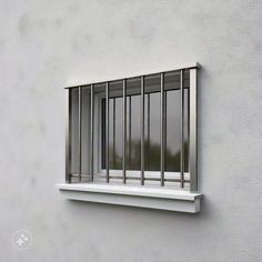 a window on the side of a building with bars hanging from it's sides