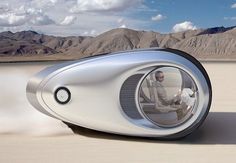 an image of a futuristic vehicle driving through the desert