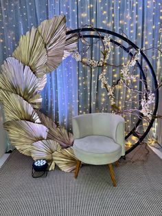 a white chair sitting in front of a wall with lights on it's sides