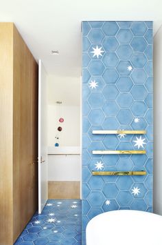 a bathroom with blue and white tiles on the walls