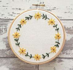 the embroidery hoop has yellow flowers on it