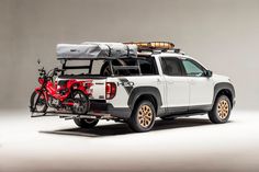 a white truck with two bikes on the back