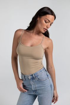 Details Kim is your everyday scoop neck tank top that features a hold-you-in fabric and full length style that sits below the natural waistline. Made in LA Pre-washed Basic Everyday Seamless Tank Top, Basic Everyday Tank Top With Seamless Construction, Basic Seamless Tank Top For Everyday, Everyday Tank Top With Built-in Bra And Scoop Neck, Basic Seamless Tank Top For Layering, Casual Scoop Neck Seamless Camisole, Seamless Sleeveless Camisole, Everyday Seamless Sleeveless Camisole, Scoop Neck Tank Top With Built-in Bra