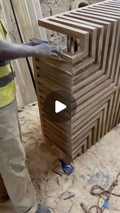 a man standing next to a wooden structure