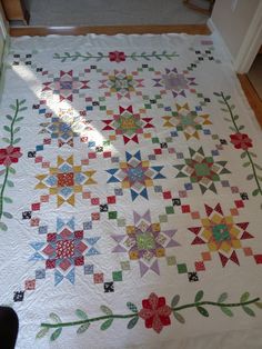 a quilt is laying on the floor in front of a door and window sill